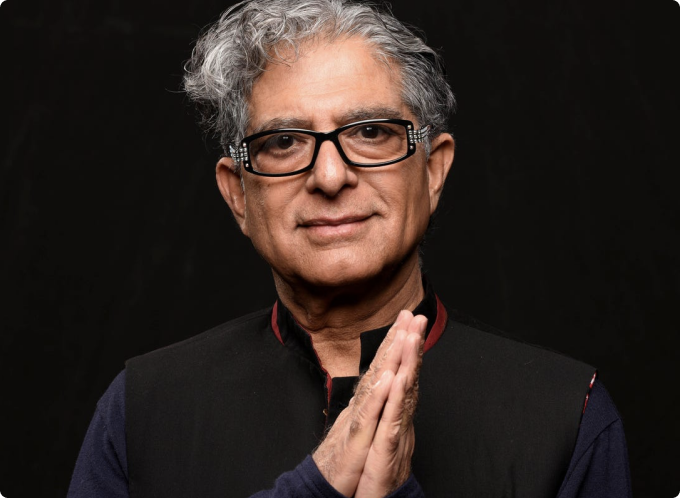 Deepak Chopra with hands in prayer angled to side